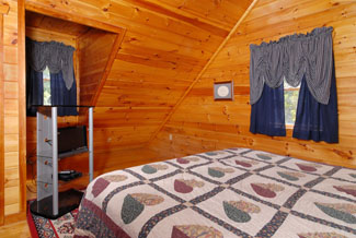 Cabin bedroom that features a television and wood interior